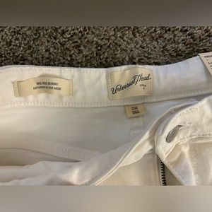 Mid-rise white skinny jeans with slight rips and snug feel!